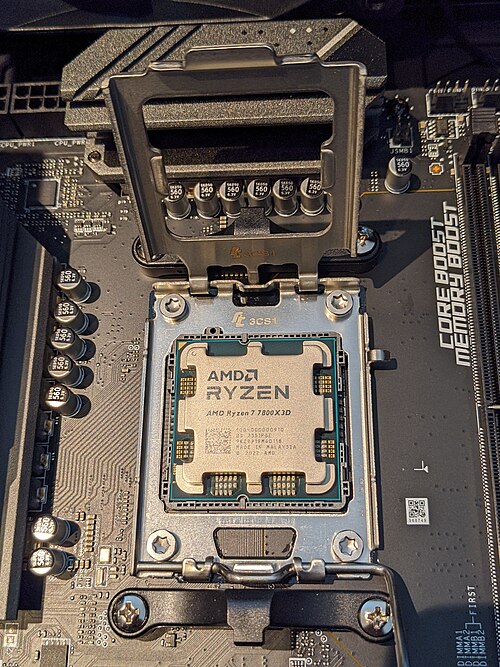 AMD Ryzen 7 7800X3D processor seated in a motherboard socket with the retention mechanism open